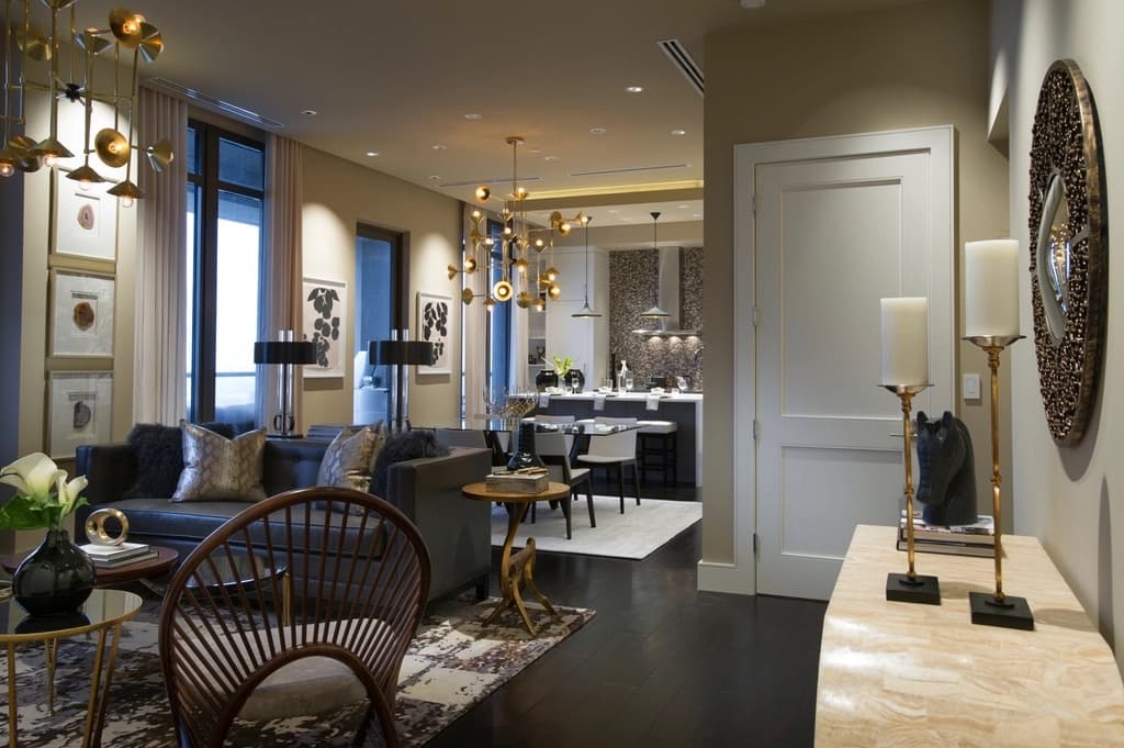 A warm, softly lit lounge with armchairs