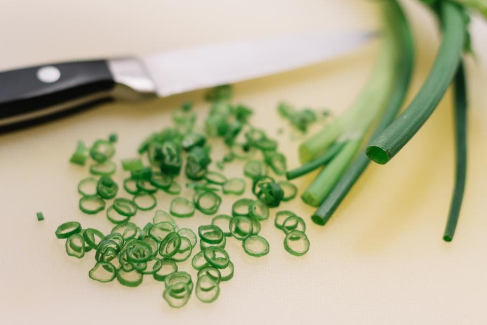 Freshly chopped spring onions on a board
