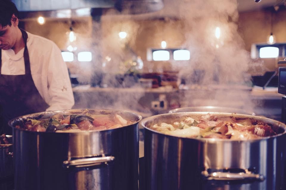 Large pots simmering in a professional kitchen